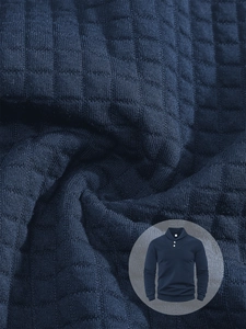 Close-up of navy blue waffle texture fabric and polo collar detail on men's long sleeve shirt