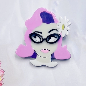Chic acrylic daisy girl brooch featuring pink hair and glasses on light background