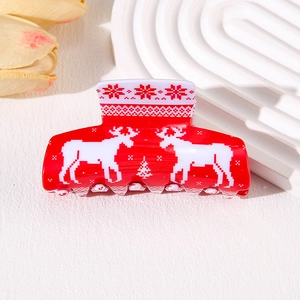 Christmas themed red hair claw clip with reindeer and snowflake patterns for holiday styling