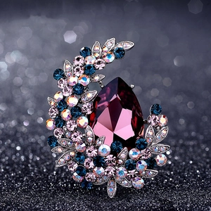 Elegant crescent moon brooch with large purple teardrop crystal and colorful rhinestones