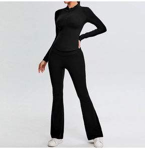 Detail of slim-fit black yoga set featuring half-zip top and flared yoga pants