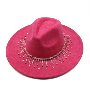 Macro detail of the sparkling rhinestone fringe trim on a rose pink suede fedora hat