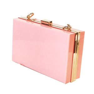 Pink acrylic box clutch evening bag with gold metal frame and clasp on white background