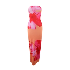 Close-up of tropical floral print on orange strapless dress showing pink and red flowers