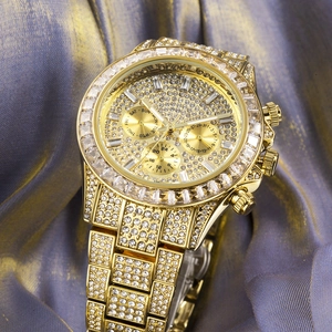 Detailed view of luxury gold iced-out watch with full diamond setting on purple silk