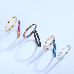 Set of seven minimalist titanium steel rings in various colors with polished mirror finish