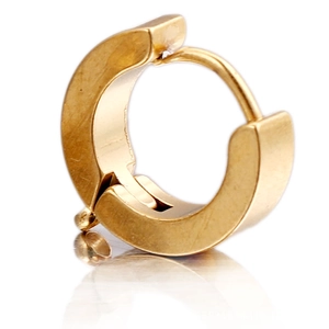Close-up of golden stainless steel hinged hoop earring with brushed metal texture