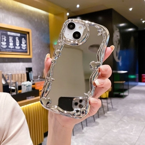 Close-up of silver wavy mirror iPhone case with 3D star and heart motifs held by a hand