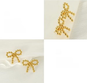 Macro view of 18k gold plated stainless steel bead bow earrings with polishing details