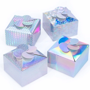 Detailed view of four silver holographic gift boxes with flower-shaped folding lids