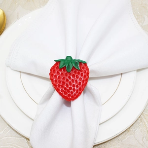 Close-up of strawberry napkin ring on a white cloth for summer table decor