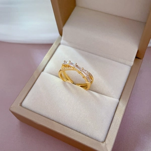 Adjustable gold plated crisscross ring with sparkling rectangular baguette zircons