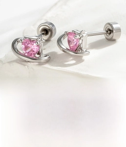 Macro detail of pink heart zircon stud earring with silver titanium steel back