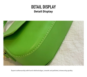 Detailed close-up of the neat stitching and green faux leather texture on the bag