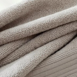 Macro shot of thick grey long-staple cotton towel showing soft absorbent terry texture
