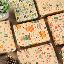 Flat lay of multiple gift boxes wrapped in various birthday theme kraft papers