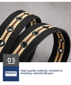 Detail of canvas belt with striped pattern and reinforced metal eyelets on gray background