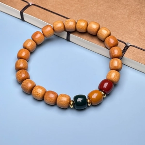 Detail of wooden beaded bracelet with colorful accents on a vintage book background