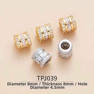 Detail view of 8mm brass barrel charms with micro-pave cubic zirconia for DIY bracelets