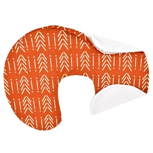 Detail of orange C-shaped nursing pillow cover with white arrow patterns and white lining