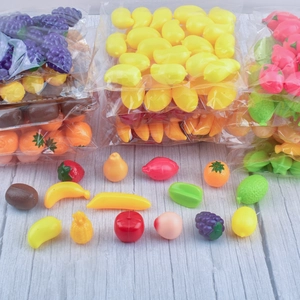 Miniature plastic fruit models for dollhouse decor and photography props on wood surface