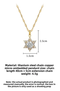 Detail view of a gold star necklace with cubic zirconia pavé and titanium steel chain