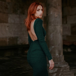 Detail of dark green backless dress with ruched waist and shimmering silk fabric