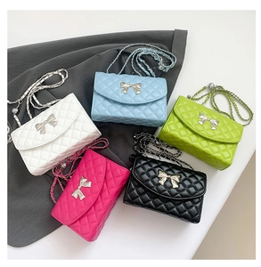 Detailed view of quilted crossbody bags in five colors with silver bow buckles