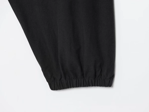 Close-up of black nylon jacket sleeve cuff showing elastic hem and stitching detail