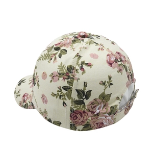Rear view detail of floral baseball cap showing beige fabric and adjustable metal buckle