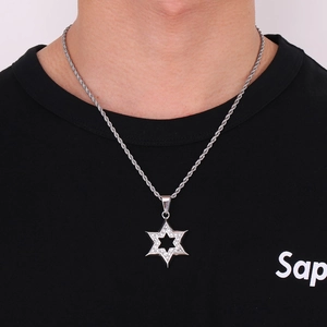 Detail shot of a silver hexagram pendant with embedded crystals on a twisted rope chain