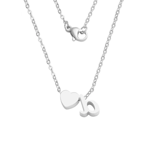 Detailed macro of silver stainless steel necklace with heart and lowercase b pendant