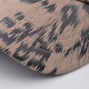 Close-up of leopard print baseball cap brim with precise stitching and suede texture