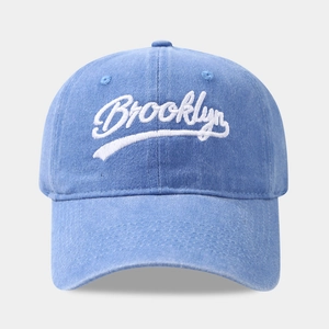 Close-up of light blue washed cotton baseball cap featuring white Brooklyn embroidery