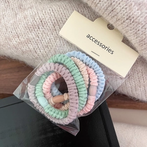 Close-up of 5-piece colorful plush elastic hair bands set in transparent packaging