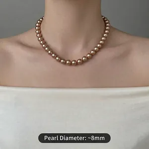 Elegant 8mm champagne gold pearl necklace showcased on a model for a vintage aesthetic