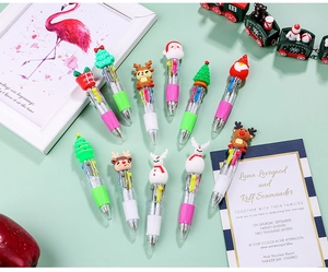 Detailed view of Christmas 4-color ballpoint pens with cartoon silicone character toppers