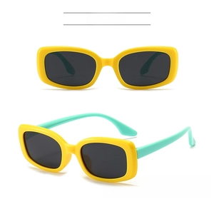 Detail view of yellow frame sunglasses with contrasting mint green silicone legs