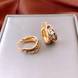 Detail of 18K gold plated U-shaped hoop earrings with colorful abalone shell and zircon