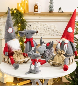 Close-up of festive Christmas gnome and reindeer plush toys in warm indoor holiday decor