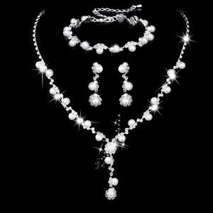 Macro shot of silver sunflower necklace set with sparkling rhinestones and white pearls