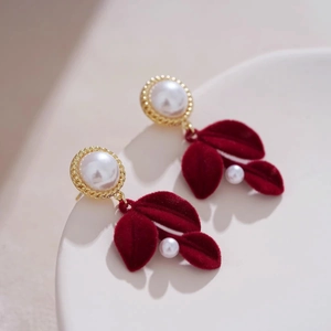 Elegant red flocked leaf earrings with pearl detail and golden vintage trim design