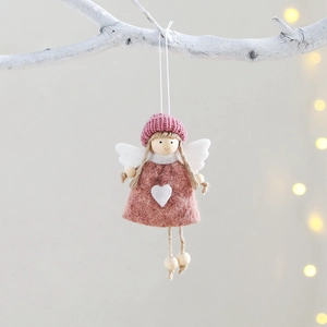 Pink and white knit plush angel ornament with heart detail hanging on a tree branch
