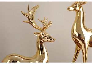 Detailed close-up of golden electroplated elk sculpture with elegant antlers and mirror finish