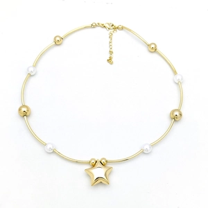 Detail of star pendant necklace featuring faux pearls and golden beads on white background