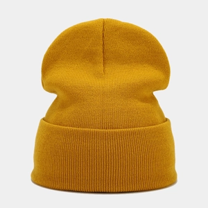Detailed view of ginger yellow knitted beanie showing fine ribbed texture and wide cuff