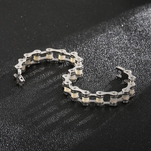 Detailed view of silver industrial bicycle chain bracelet with white resin rollers and clasp