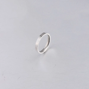 Minimalist silver mirror titanium steel ring 3mm simple band on grey industrial background