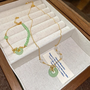 Parure collier et bracelet feuilles de ginkgo dorées avec pierres vertes en boîte