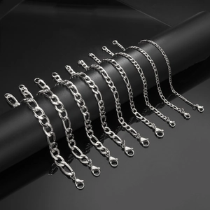 Macro shot of silver stainless steel Figaro chains in various widths with lobster clasps